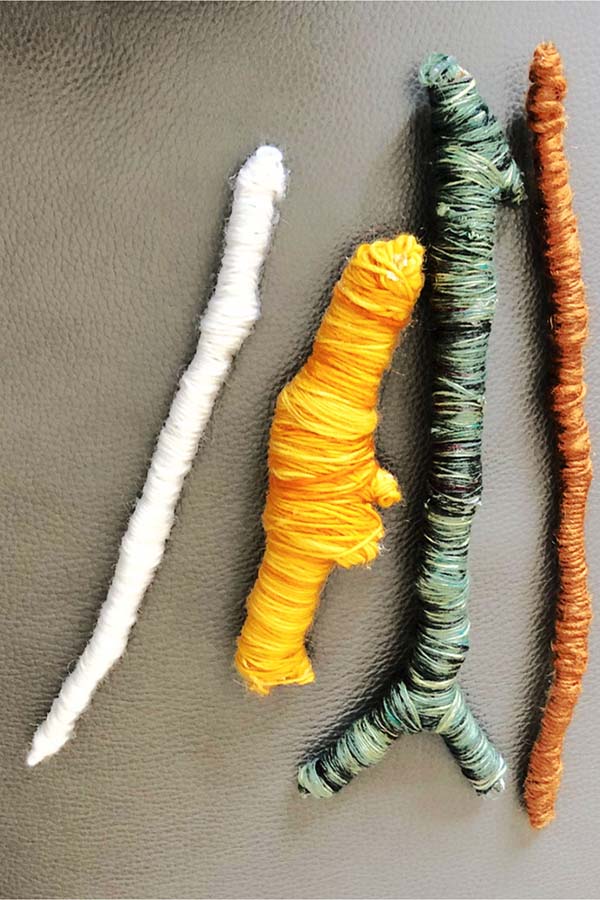 Winding wool yarn around a stick can fulfill rotation play schemas