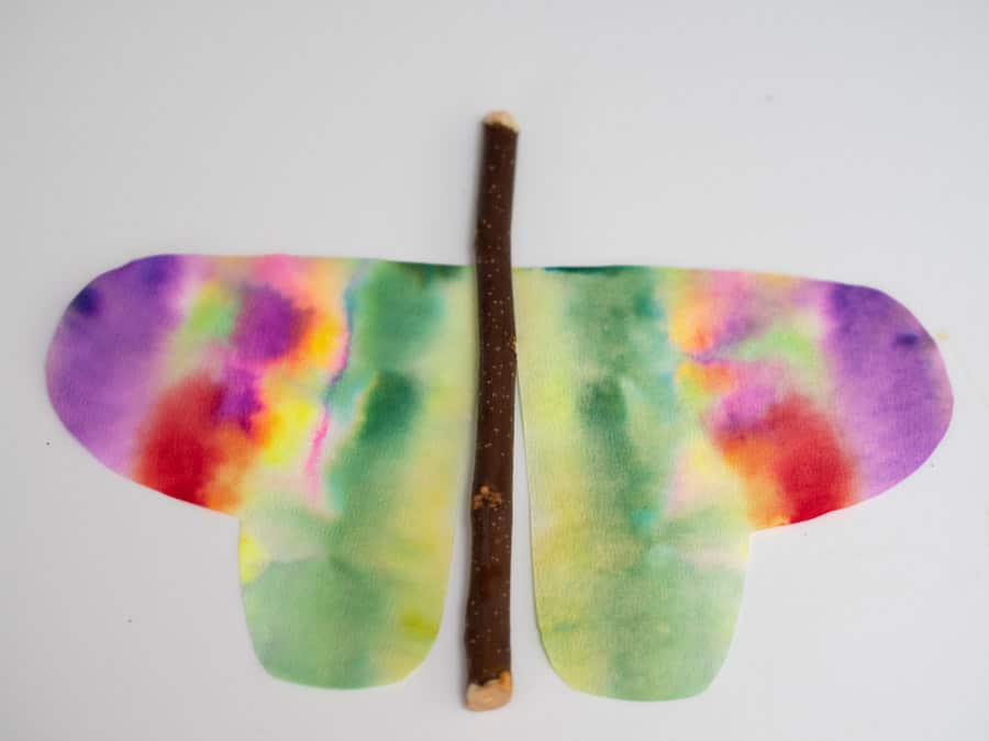 Colourful butterfly made from a stick and colourful paper