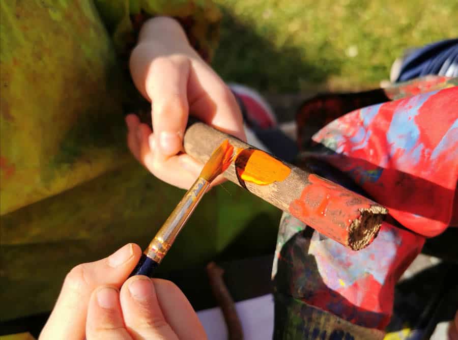 Child painting a stick