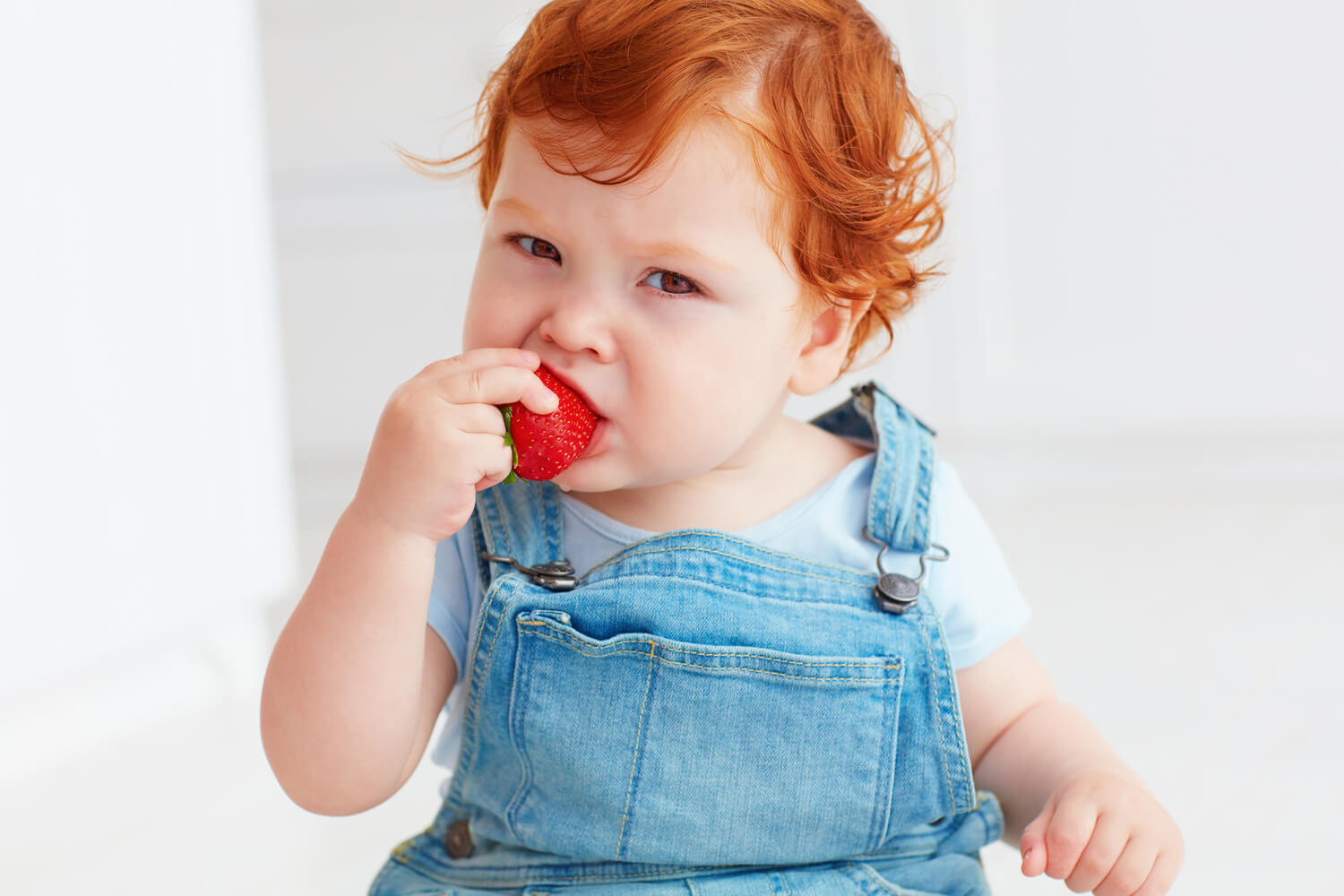 baby tasting strawberry