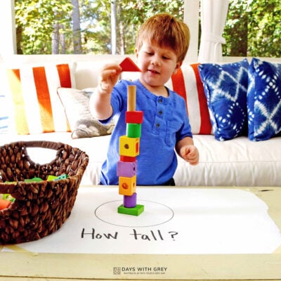 kid stacking colored blocks