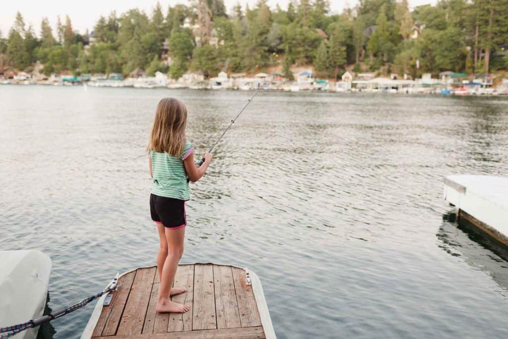 A child fishing on a dock
Description automatically generated with medium confidence