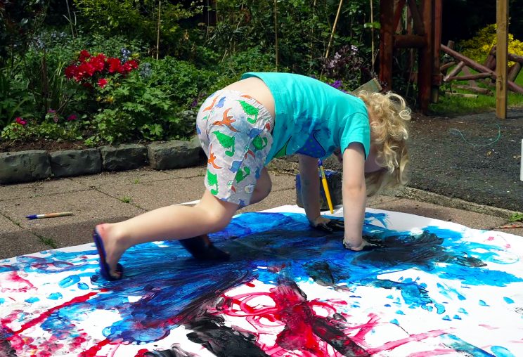 Child exploring paint
