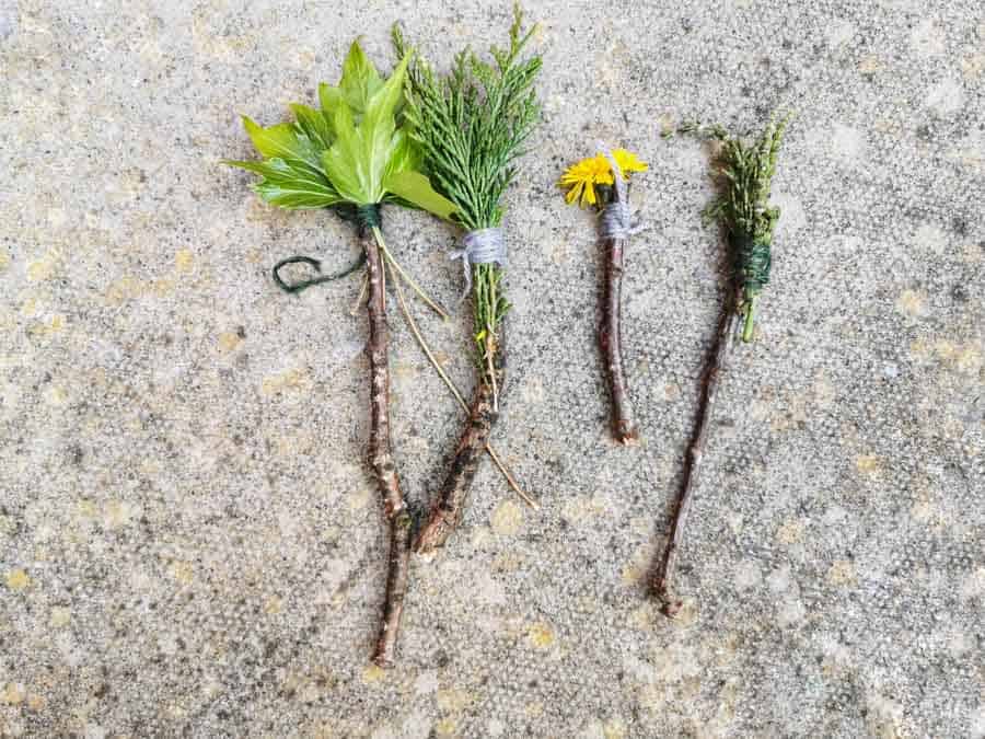 sticks with flowers and leaves tied to them