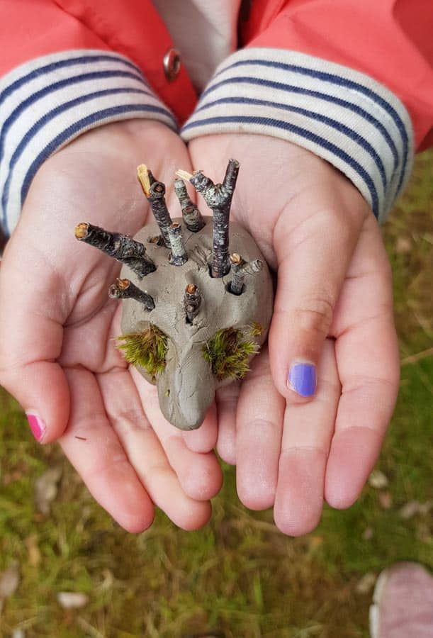 Clay hedgehog in child's hands