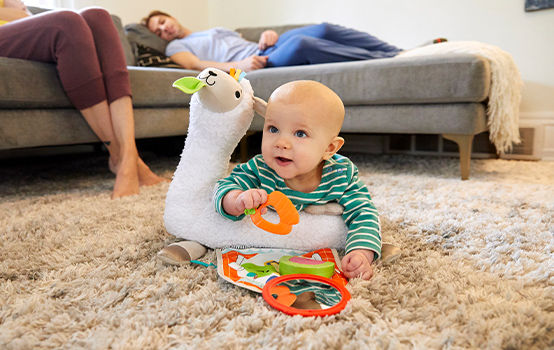 Baby laying on Grow-with-Me Tummy Time Llama