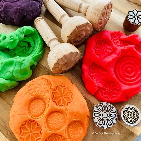 Homemade playdough pictured with some playdough stamps